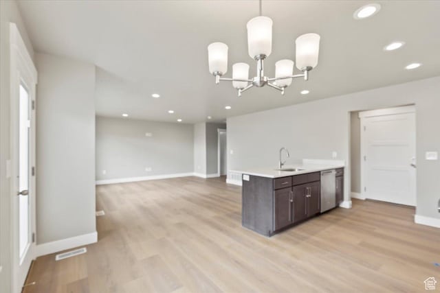 kitchen with dark brown cabinetry, dishwasher, light wood-type flooring, light countertops, and a sink