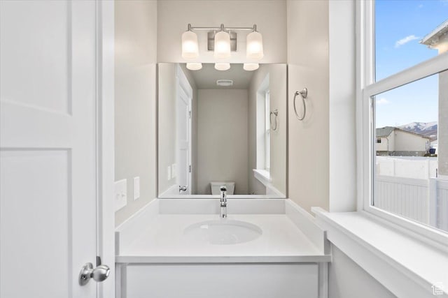 bathroom featuring toilet and vanity
