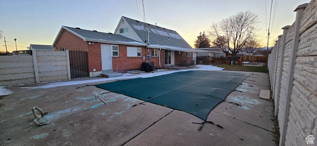 1600 W 4300 S, Salt Lake City, UT 84123 - rear view of property with brick siding, a fenced backyard, a patio, entry steps, and roof with shingles
