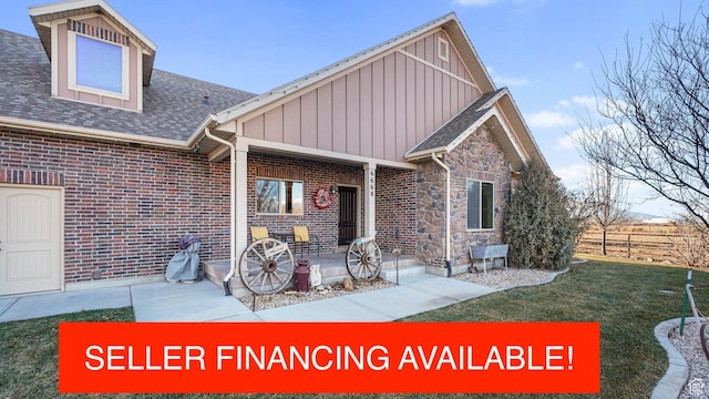 6668 S 3200 W, Spanish Fork, UT 84660 - back of house featuring board and batten siding, a lawn, brick siding, fence, and a shingled roof