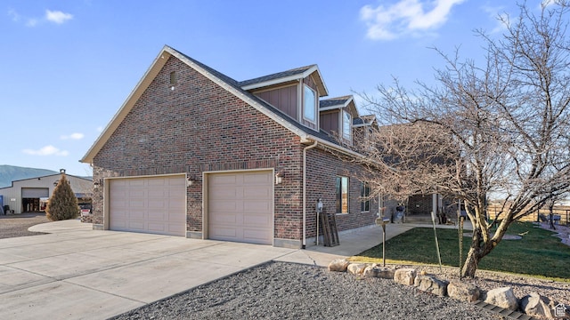 6668 S 3200 W, Spanish Fork, UT 84660 - view of side of home with brick siding, an attached garage, a yard, and concrete driveway