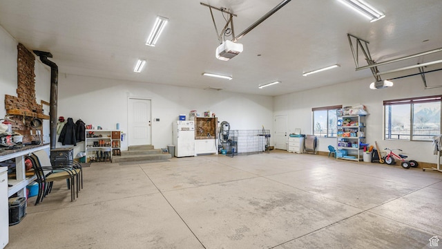 6668 S 3200 W, Spanish Fork, UT 84660 - garage featuring freestanding refrigerator and a garage door opener