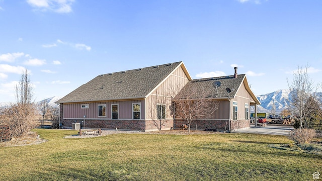 6668 S 3200 W, Spanish Fork, UT 84660 - back of house featuring roof with shingles, board and batten siding, a yard, and brick siding