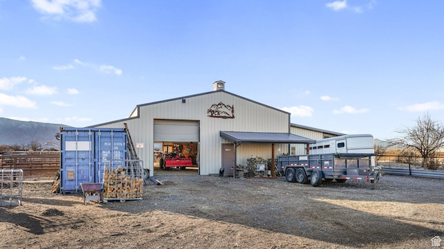 6668 S 3200 W, Spanish Fork, UT 84660 - view of building exterior featuring a detached garage, fence, a mountain view, and dirt driveway