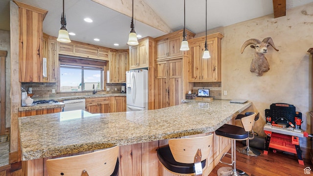 6668 S 3200 W, Spanish Fork, UT 84660 - kitchen with backsplash, wood finished floors, a sink, a peninsula, and white appliances