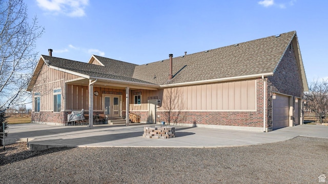 6668 S 3200 W, Spanish Fork, UT 84660 - view of front of home with roof with shingles, french doors, brick siding, board and batten siding, and an attached garage