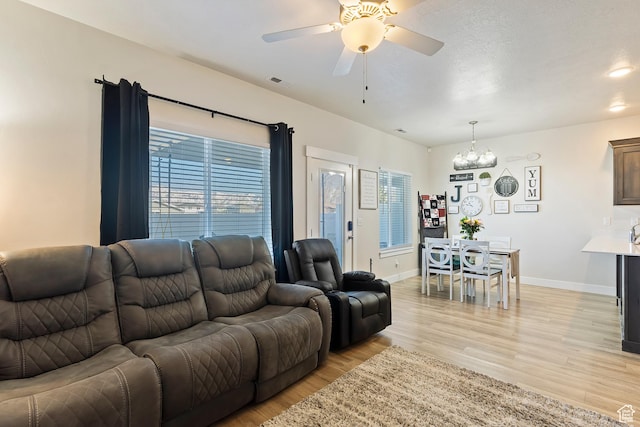 2390 W Jade Way Unit 2, West Haven, UT 84401 - living area featuring light wood-style floors, visible vents, baseboards, and ceiling fan with notable chandelier