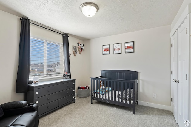 2390 W Jade Way Unit 2, West Haven, UT 84401 - carpeted bedroom featuring a nursery area, baseboards, and a textured ceiling