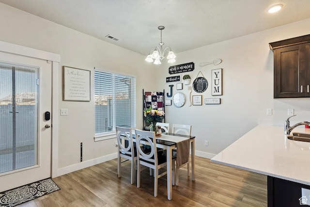 2390 W Jade Way Unit 2, West Haven, UT 84401 - dining area with light wood finished floors, baseboards, and an inviting chandelier