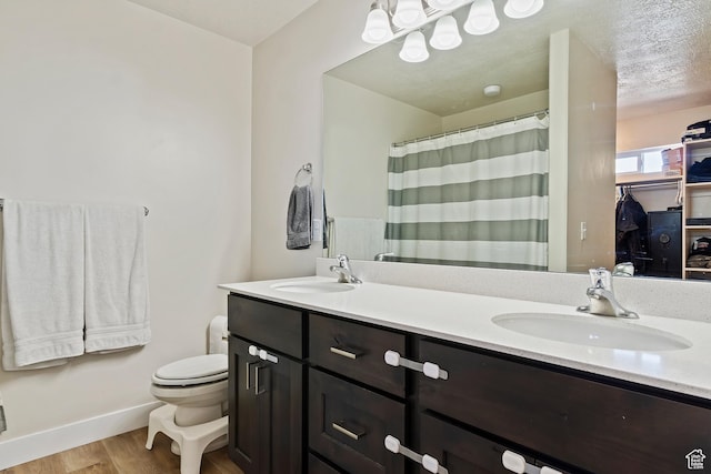 2390 W Jade Way Unit 2, West Haven, UT 84401 - full bathroom with double vanity, a sink, toilet, and wood finished floors