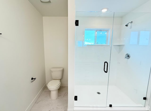 bathroom with a stall shower, marble finish floor, baseboards, and toilet