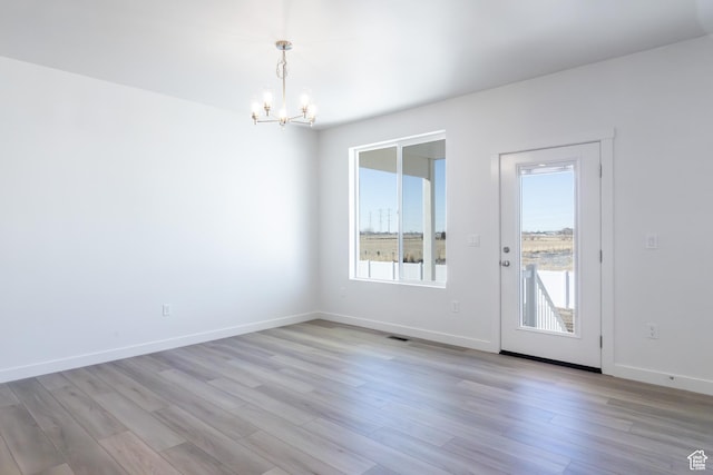 3047 N 2875 W Unit 7, Plain City, UT 84404 - unfurnished dining area featuring a chandelier, healthy amount of natural light, and light wood finished floors