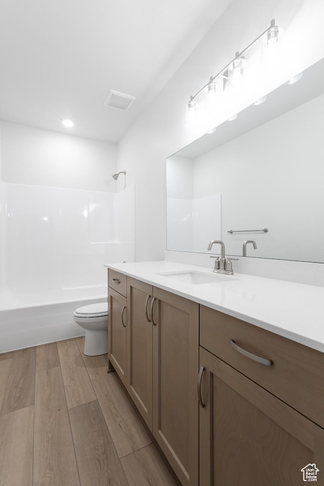 3047 N 2875 W Unit 7, Plain City, UT 84404 - full bathroom with vanity, toilet, shower / bathtub combination, and wood finished floors