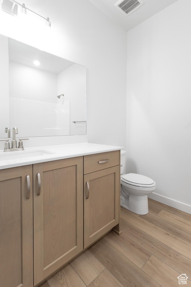 3047 N 2875 W Unit 7, Plain City, UT 84404 - full bath featuring wood finished floors, toilet, vanity, baseboards, and a shower