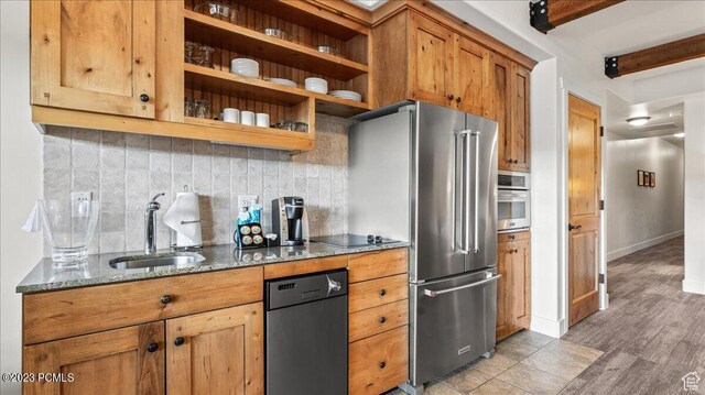 1476 Newpark Blvd Unit 302, Park City, UT 84098 - kitchen with sink, tasteful backsplash, dark stone counters, beam ceiling, and black appliances