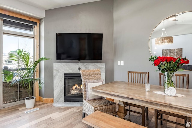 14084 N Council Fire Trl Unit 14D, Kamas, UT 84036 - dining area with a high end fireplace and light hardwood / wood-style floors