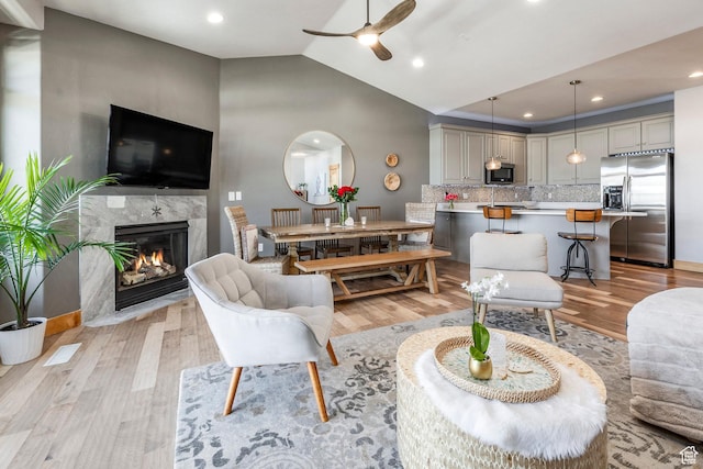 14084 N Council Fire Trl Unit 14D, Kamas, UT 84036 - living room featuring lofted ceiling, a fireplace, light hardwood / wood-style flooring, and ceiling fan