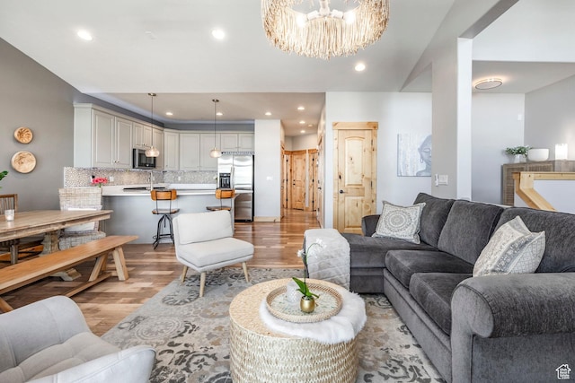 14084 N Council Fire Trl Unit 14D, Kamas, UT 84036 - living room with sink, a chandelier, and light wood-type flooring