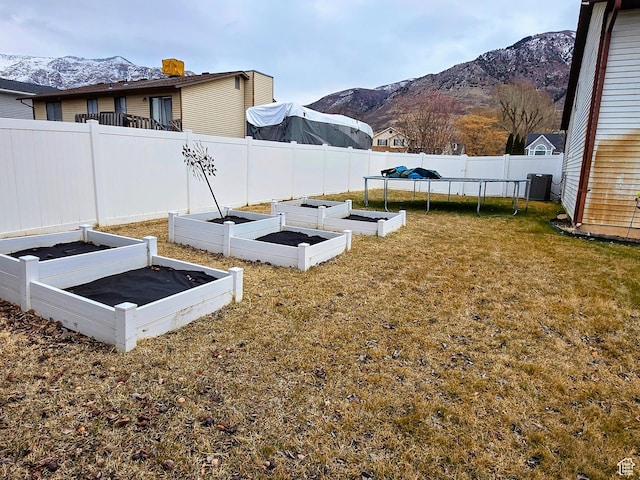 view of storm shelter featuring a mountain view and a lawn