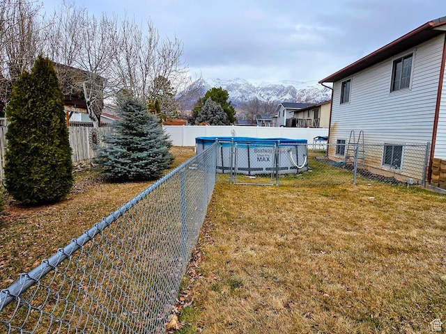 view of yard with a mountain view and a covered pool