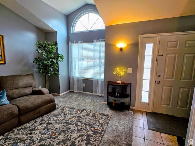 tiled foyer entrance featuring lofted ceiling