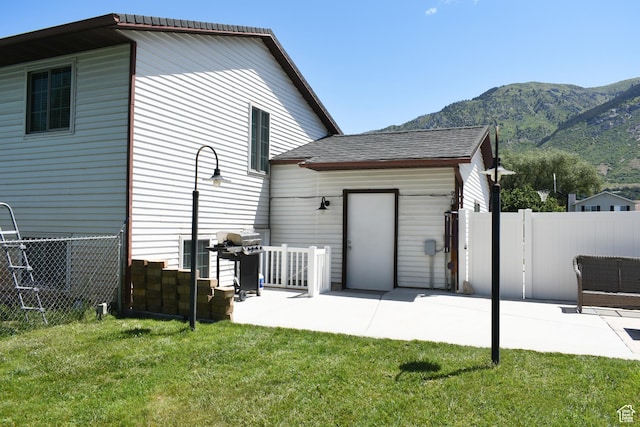 1797 N 700th St E, North Ogden, UT 84414 - rear view of property with a mountain view, a patio area, and roof with shingles
