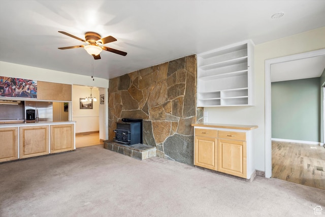 1320 Country Hills Dr, Ogden, UT 84403 - unfurnished living room with a wood stove, light carpet, and ceiling fan