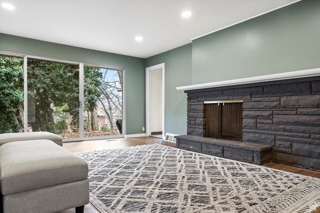 1320 Country Hills Dr, Ogden, UT 84403 - living room featuring hardwood / wood-style flooring and a stone fireplace