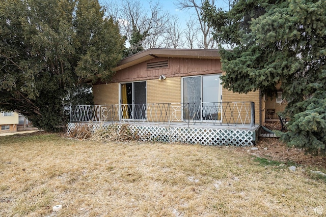 1320 Country Hills Dr, Ogden, UT 84403 - back of house with a wooden deck and a lawn