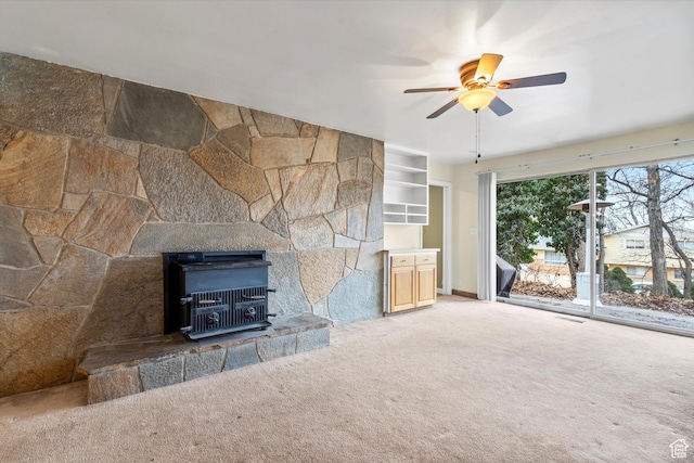 1320 Country Hills Dr, Ogden, UT 84403 - unfurnished living room with built in shelves, carpet floors, and ceiling fan