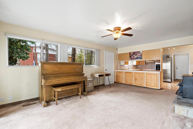 1320 Country Hills Dr, Ogden, UT 84403 - miscellaneous room featuring a wood stove, light colored carpet, and ceiling fan