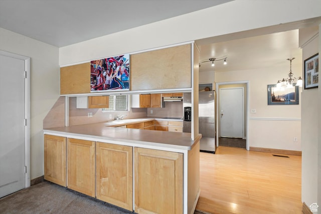 1320 Country Hills Dr, Ogden, UT 84403 - kitchen with kitchen peninsula, black electric stovetop, light hardwood / wood-style floors, stainless steel fridge with ice dispenser, and an inviting chandelier