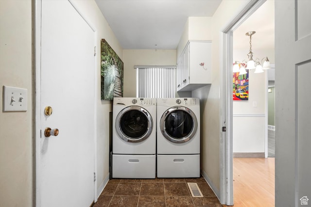 1320 Country Hills Dr, Ogden, UT 84403 - laundry room with cabinets, a notable chandelier, and independent washer and dryer