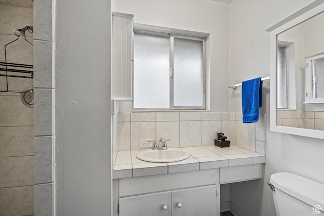 1320 Country Hills Dr, Ogden, UT 84403 - bathroom featuring tasteful backsplash, vanity, and toilet