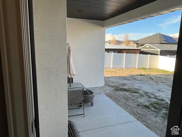 view of patio featuring fence