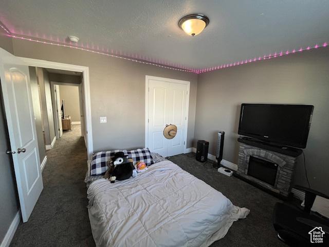 carpeted bedroom with a closet and baseboards