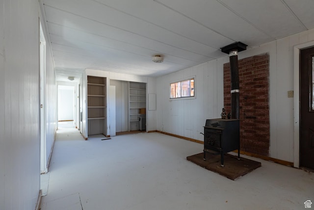unfurnished living room with a wood stove