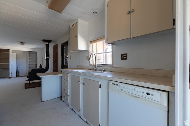 kitchen with white dishwasher, sink, and a wood stove