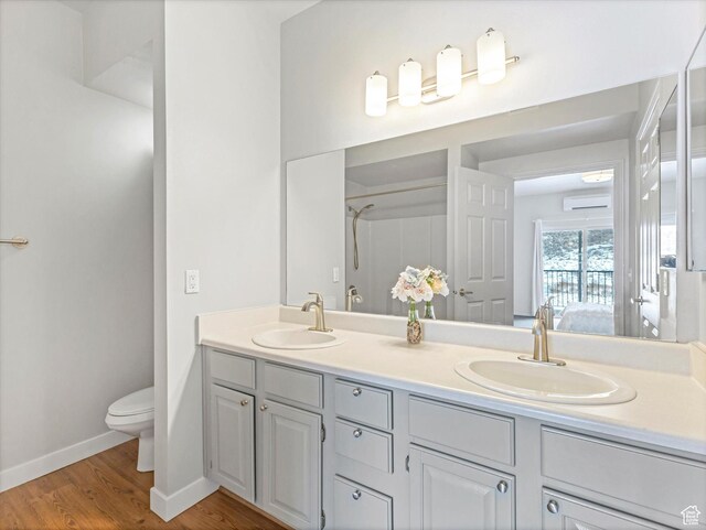 900 Bitner Rd Unit K17, Park City, UT 84098 - bathroom with wood-type flooring, a wall mounted air conditioner, vanity, and toilet