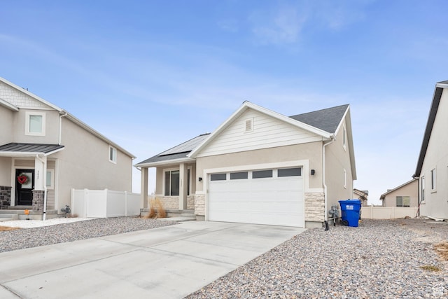 view of front of house with a garage and solar panels