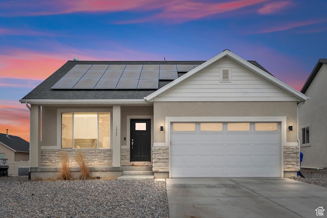 view of front of house with a garage and solar panels