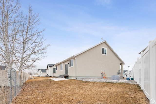 rear view of house with a lawn