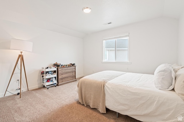 bedroom featuring lofted ceiling and carpet floors