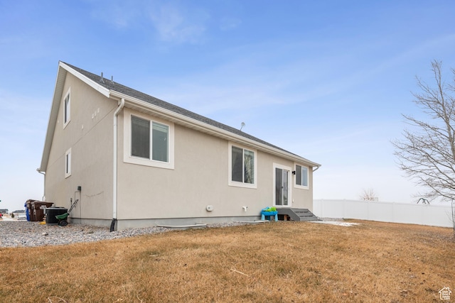 rear view of property with a yard