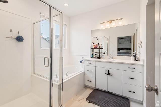 bathroom featuring vanity and separate shower and tub