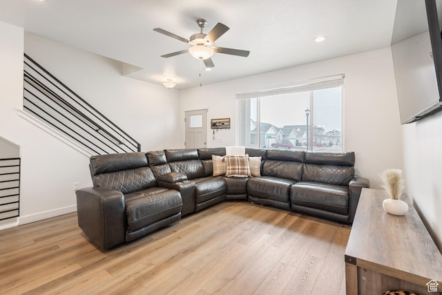 living room featuring ceiling fan and light wood-type flooring