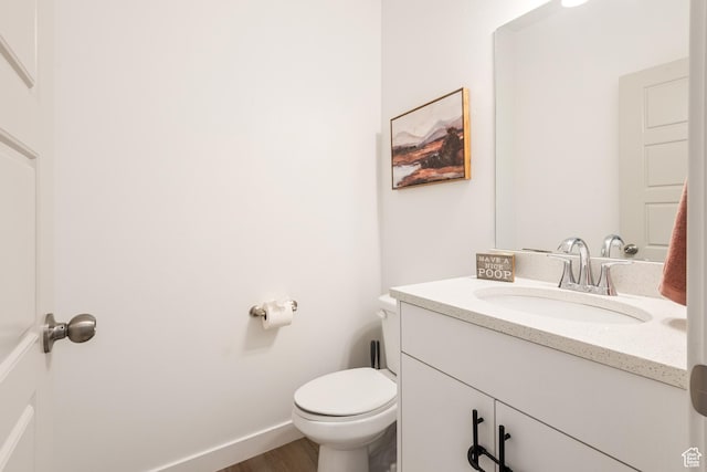 bathroom with vanity, wood-type flooring, and toilet