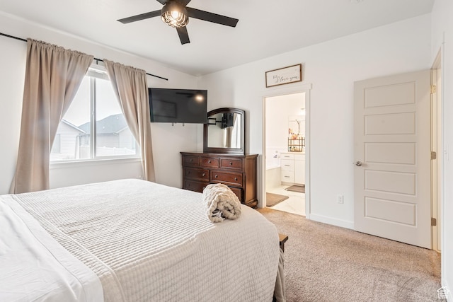 bedroom with light carpet, connected bathroom, and ceiling fan