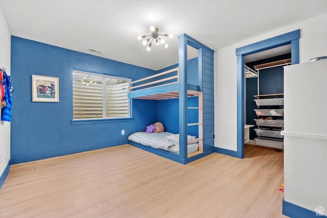 bedroom featuring hardwood / wood-style floors and a textured ceiling