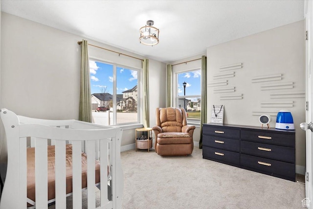 carpeted bedroom with a crib